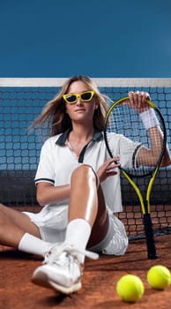 Tennis player with racket on the court outdoors. Download a photo of a tennis player to advertise sporting events in social media.