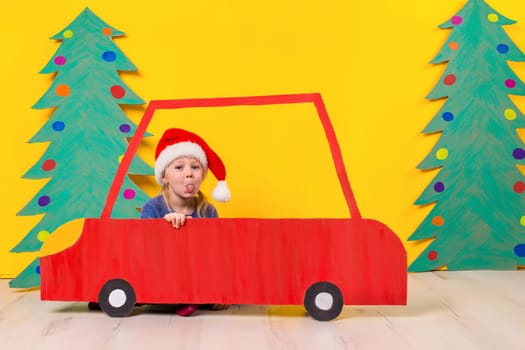 Child in red Christmas car. Xmas holiday concept