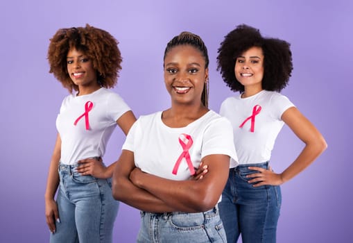 Three African American Ladies With Pink Ribbons Over Purple Background