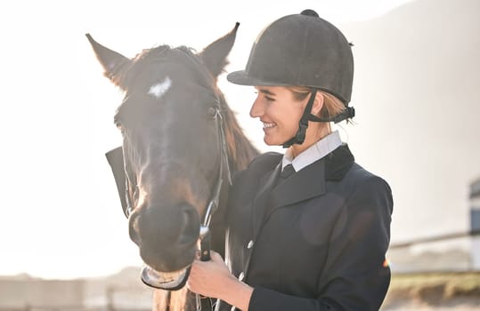 Equestrian, horse riding and a woman with an animal on a ranch for sports, training or a leisure hobby. Face, smile or competition and a happy young rider in uniform with her stallion or mare outdoor