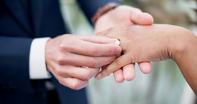 Couple, hands and ring for marriage, love or wedding in ceremony, commitment or support together. Closeup of people getting married, vows or accessory for symbol of bond, relationship or partnership