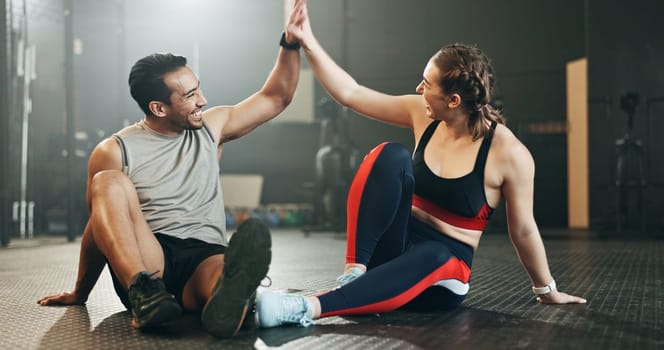 Happy couple, high five and team in fitness workout, exercise motivation or gym together. Man and woman touching hands in success for sports training, healthy wellness or body goals at health club