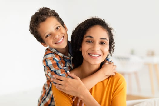 Mom And Kid Son Sharing Warm Embrace Smiling At Home