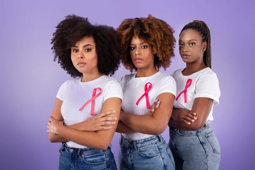 African Women With Pink Breast Cancer Ribbons Posing, Purple Background