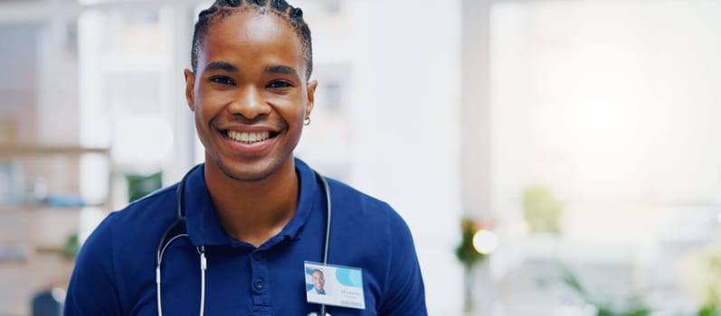 Black man, doctor and smile on face in clinic for healthcare services, excited or happy for job. African medic, male nurse and happiness in portrait for wellness service, medical career or workplace.