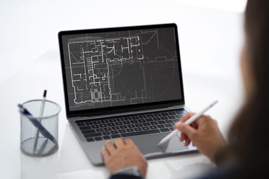 Architect designer using laptop and stylus while working in office