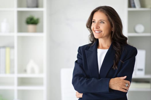 Confident smiling middle aged woman manager posing at office