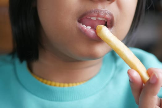 child eating french fries close up