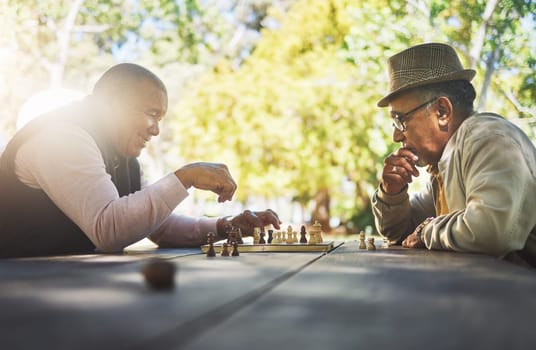 Elderly men in park, chess game and strategy with competition or challenge, friends in retirement and intelligence. Thinking, planning and contest outdoor, concentration on boardgame and recreation