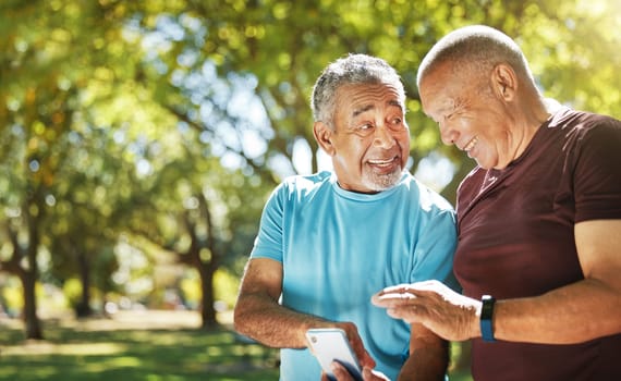 Talking, men and a phone in a park for fitness, training results and conversation about an app. Happy, communication and senior friends with a mobile to monitor health after exercise or running