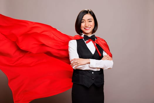 Receptionist in fluttering red cape