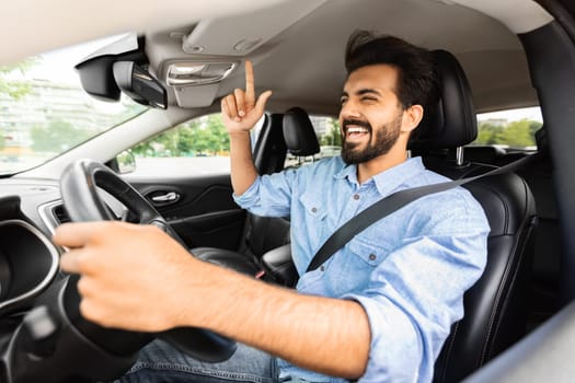 Emotional arab guy driver having fun during car trip