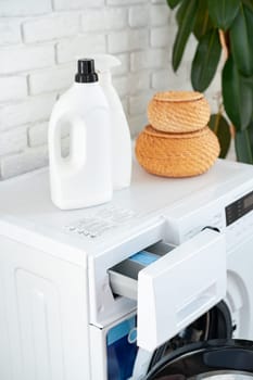 Detergent bottle on washing machine in a laundry room