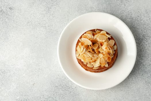 Tart pie with almond petals on plate