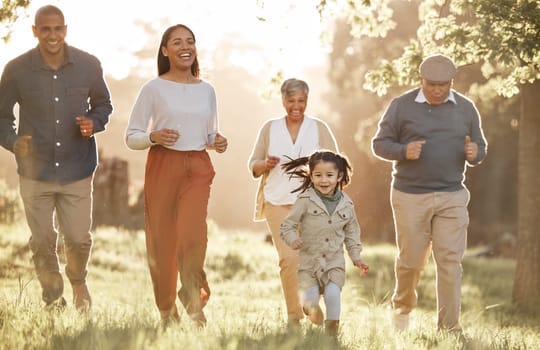 Park, running and child with parents or grandparents on grass field for freedom, adventure or playing in summer. Family, men or women with fun or love in forest with sunshine for care or happiness