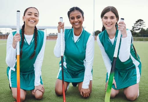 Portrait, smile and hockey with a woman team outdoor on a field for sports, a game or competition together. Fitness, exercise and diversity with a happy young athlete group on an astro turf court