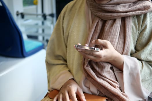 young women using smart phone inside of metro train