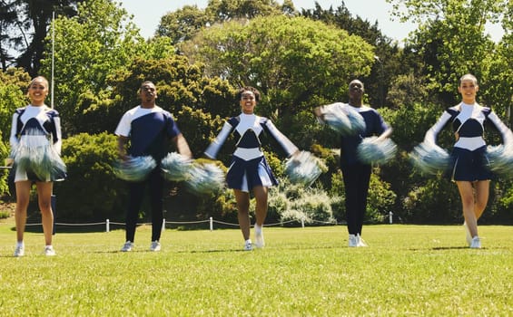 Motion blur, energy and a cheerleader group of young people outdoor for a training routine or sports event. Motivation, teamwork and diversity with a happy cheer squad on a field together for support