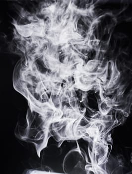 Smoke, incense or gas in a studio with dark background by mockup space for magic effect with abstract. Fog, steam or vapor mist moving in air for cloud smog pattern by black backdrop with mock up.