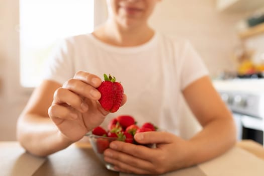 a woman picks strawberries to make breakfast