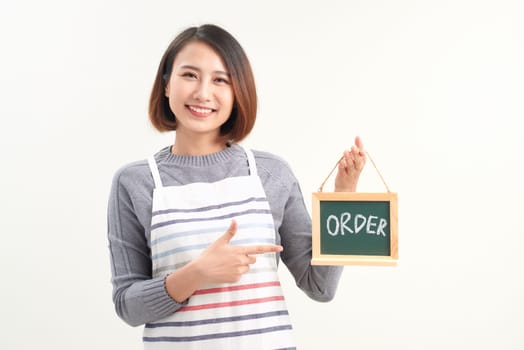 Portrait of waitress showing chalkboard with order sign on white
