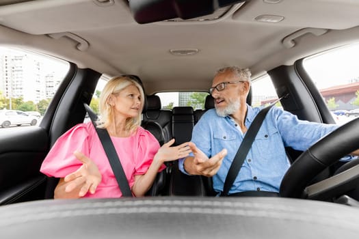 Emotional elderly couple having conflict in car