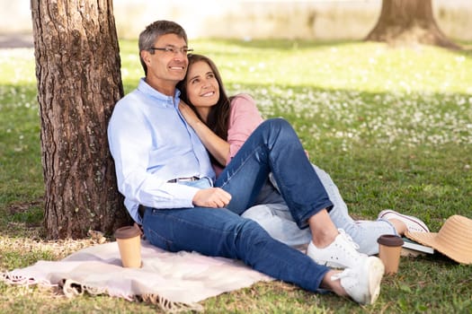 Outdoor Date. Romantic Mature Spouses Relaxing Together On Lawn In Park