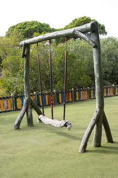 Large playground swings made from solid tree trunks