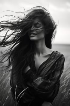 Happy girl with long hair in the field. Black and white picture. High quality photo