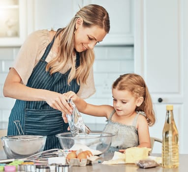 Mom, girl kid and teaching for cooking, development and skills with bonding, love and care in family home. Baking, mother and daughter with bowl, flour and eggs on table, kitchen and helping for food