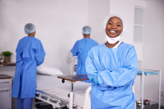Happy black woman, doctor and arms crossed of professional in ICU, medical or team in healthcare service at hospital. Portrait of African female person, surgeon or nurse smile in confidence at clinic