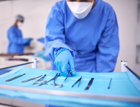 Nurse, surgery and prepare tools in operation, medical equipment and scissors for procedure. Surgeon, hospital and scrubs for protection, medical service and surgical tools in theatre for emergency