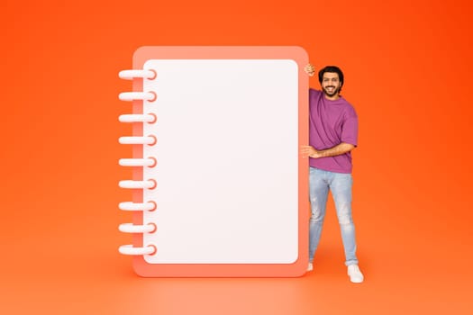 Happy handsome millennial indian man in casual show plan with copy space, recommendation work planning