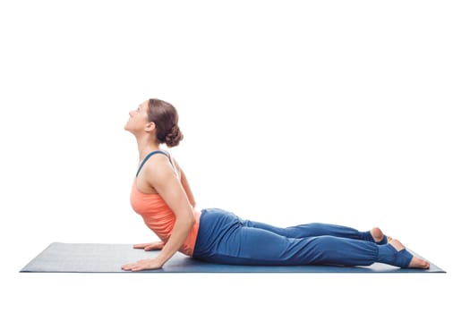 Sporty fit yogini woman practices yoga asana bhujangasana