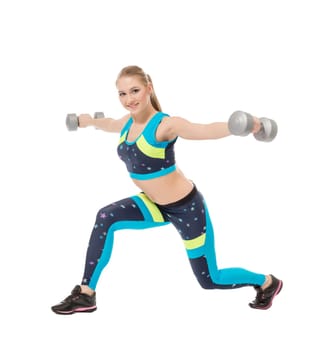 Cute sporty girl posing with dumbbells