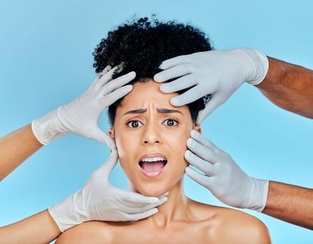 Skincare, portrait of scared woman with hands on face in studio for plastic surgery consultation. Model with stress, fear and anxiety for beauty, dermatology or collagen therapy on blue background.
