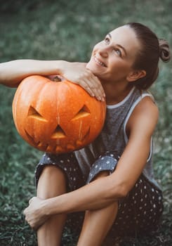 Pretty woman with Halloween pumpkin head