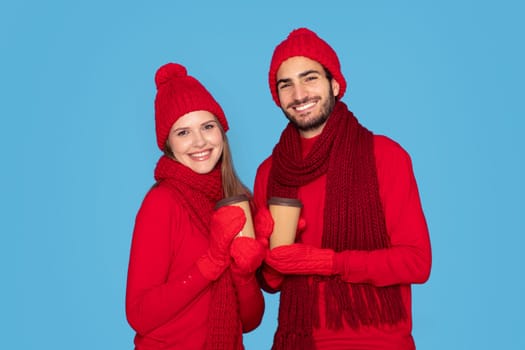 Happy Man And Woman Wearing Mittens Holding Cups With Takeaway Coffee