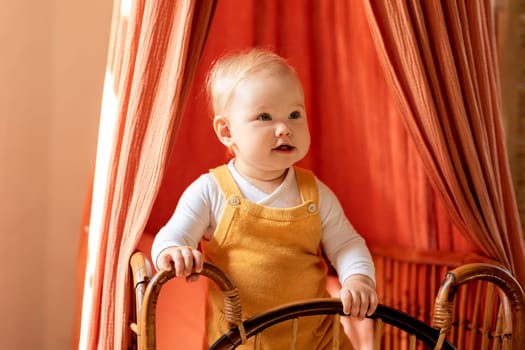 Portrait Of Cute Infant Boy Or Girl Standing In Retro Wooden Crib At Home,