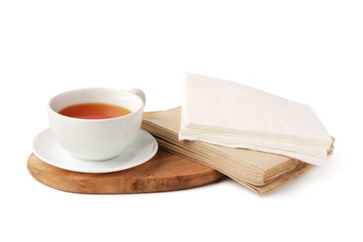 Cup of tea and paper napkin on white background