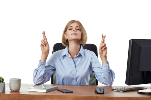 businesswoman showing fingers crossed for good luck in office