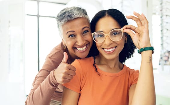 Portrait, senior and women with glasses and thumbs up for vision, wellness or optometry at optometrist. Elderly, face and person with happiness for eyewear, eye care and yes for success or service