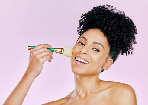 Portrait, happy woman and brush for makeup in studio for mockup in beauty on pink background. African, female model and smile in confidence for powder, foundation or cosmetic for results in coverage
