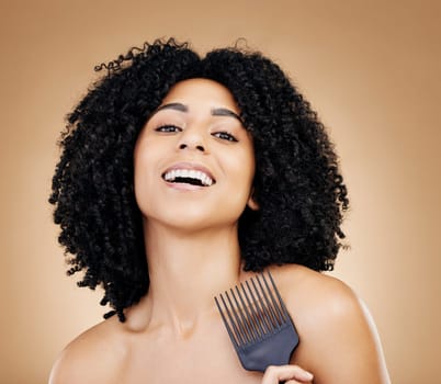Portrait, hair care and woman with a comb, afro and salon treatment with volume on brown background. Face, person or model with grooming, shine or glow with beauty, texture or aesthetic with keratin.