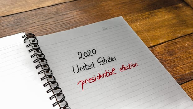 2020 Unites States, presidential election, handwriting  text on paper, political message. Political text on office agenda. Concept of democracy, voting, politics. Copy space.