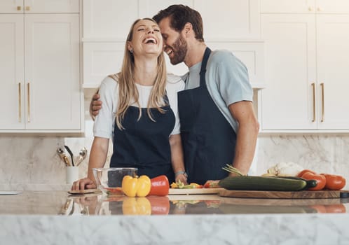 Funny, kitchen and couple with happiness, cooking and bonding with love, weekend break and lunch. Home, happy man and woman with humor, food and ingredients with health, marriage and relationship