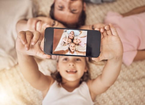 Phone, selfie and top view of family on a floor with love, fun and smile for social media post at home. Smartphone, profile picture and girl children with parents in a living room for weekend memory