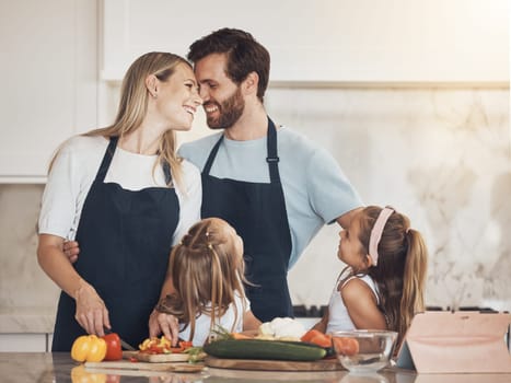 Cooking, kids or happy parents with food or siblings for a healthy vegan diet in a family house. Smile, vegetables or mom bonding in kitchen with father or children learning a dinner recipe together