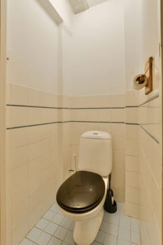 a toilet with a black seat in a white bathroom