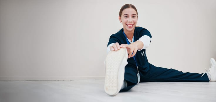 Portrait, space and a nurse stretching on the floor of a studio, getting ready for healthcare or medical treatment. Smile, warm up and a happy young volunteer or medicine professional on mockup